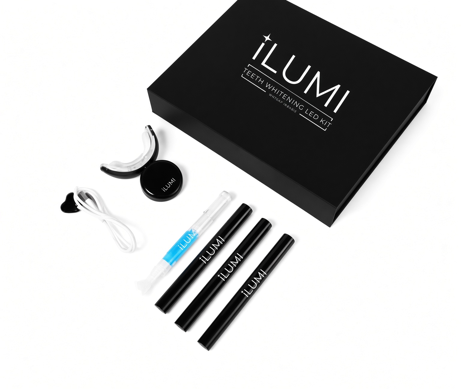 ILUMI LED Teeth Whitening Kit unboxed flat lay — magnetic box, LED mouthpiece, charging cable and three whitening gel pens, formulated by Harvard-trained endodontist Dr. Dave Steuer